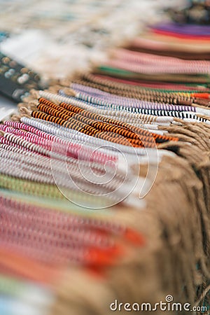 High-angle view of a pile of striped bracelets displayed on a table Stock Photo