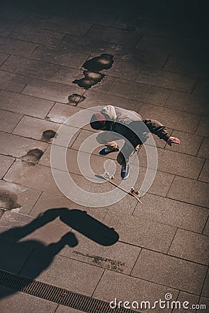 high angle view of skateboarder performing jump trick outdoors Stock Photo