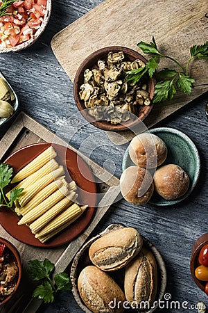 Baby sweetcorn, cooked mushrooms, tomato and buns Stock Photo