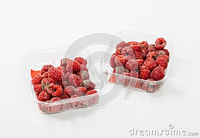 High-angle view of spoilt raspberries in plastic clamshell containers on a white background Stock Photo