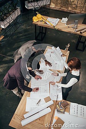 high angle view of team of architects working with architectural plans Stock Photo