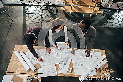 high angle view of team of architects working with building plans Stock Photo