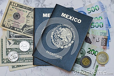 High angle view of two Mexican Passports on dollars and pesos on the table under the lights Stock Photo