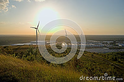 warehouses and wind mills against a sunset sky Editorial Stock Photo