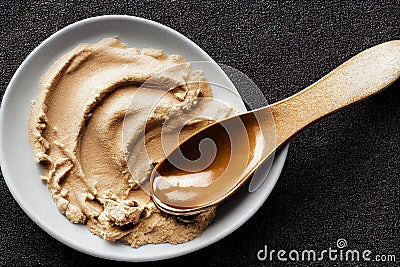 High-calorie protein peanut butter in bowl with spoon Stock Photo