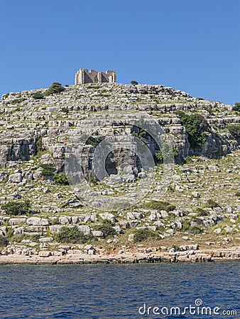 High cliff in Kornati islands Croatia with castle Stock Photo