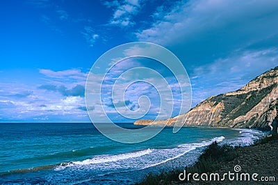 High cliff by the ocean, beautiful ocean view, beautiful sky with white clouds Stock Photo