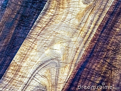 High contrast close-up view of a seasoned wooden kitchen cutting board Stock Photo