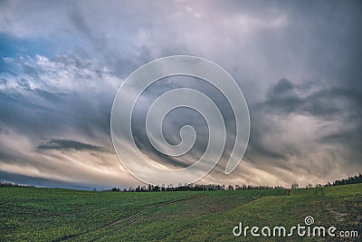 high contrast clouds on blue sky over natural landscape - vintage retro look Stock Photo