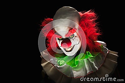 Scary clown on a dark background Stock Photo