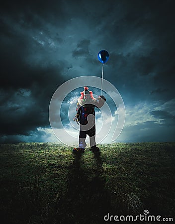 Scary clown on a dark background Stock Photo