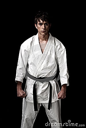 High Contrast karate male fighter on black Stock Photo