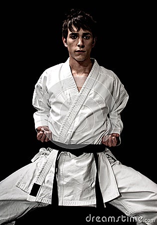 High Contrast karate young male fighter on black Stock Photo