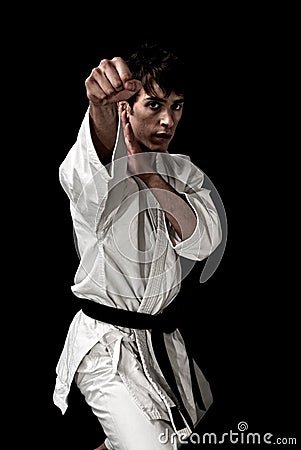 High Contrast karate young male fighter on black Stock Photo