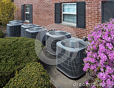 Air conditioning units outside an apartment complex Stock Photo