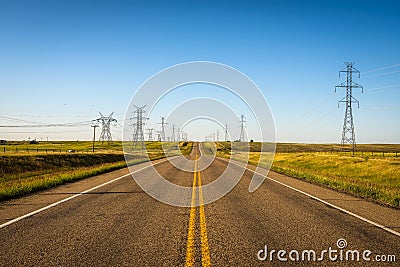 Electricity Pillars along an empty road in Alberta, Canada Stock Photo