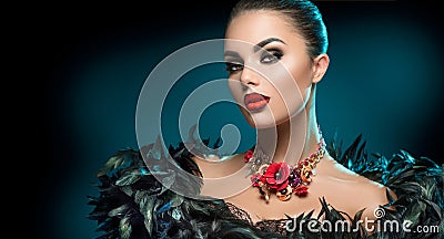 High Fashion Model Girl Portrait with Trendy gothic make-up, Black Hair style, Make up, dark accessories over black background Stock Photo