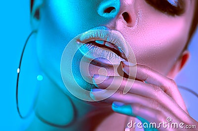 High fashion model woman in colorful bright neon lights posing in studio. Beautiful girl Stock Photo