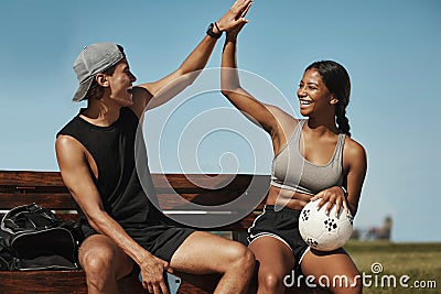 High five, soccer and team celebrate winning match, happy and smile on bench with ball together. Football, players and Stock Photo