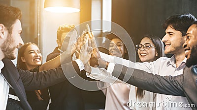 High-five for success. Diverse group of business colleagues in office Stock Photo