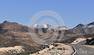 High himalayan road and snowcapped peak near bum la pass Stock Photo