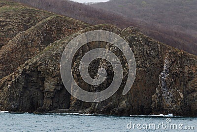 The high impregnable cliffs of Reinike Island near Vladivostok Stock Photo