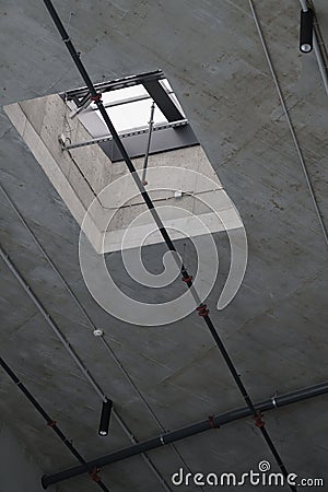 A high industrial, loft room with a ventilation and smoke exhaust flap Stock Photo