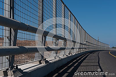 High metal guardrail along an empty highway Stock Photo