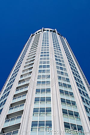 High modern building on background blue sky. Stock Photo
