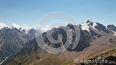 High mountains covered with snow in places. Stock Photo