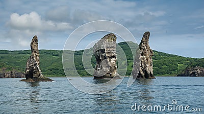 High picturesque rocks rise above the ocean. Stock Photo