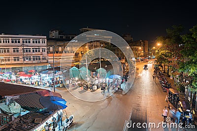 high point of view onto city street markets with people and vehicles blurred in motion Editorial Stock Photo