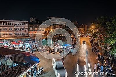 high point of view onto city street markets with people and vehicles blurred in motion Editorial Stock Photo