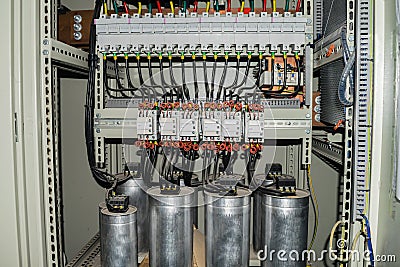 High-power capacitors installed in the electric box. Powerful electrical switches. Stock Photo