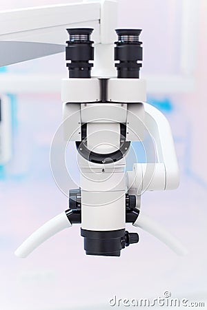 Dental binocular microscope on the background of modern dental clinic. Professional medical equipment. Stock Photo