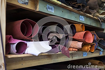 High quality multicolored dyed leather on shelves. Stock Photo