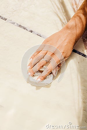 High-resolution closeup shot of a female hand waxing a surfboard Stock Photo