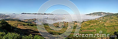 High resolution panorama - typical Madagascar landscape at Alakamisy Ambohimaha region fog rolls over green valley with terraced Stock Photo