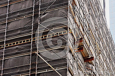 Dark Cladding on Construction Site Scaffolding Stock Photo