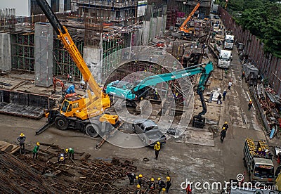 High rise building and cranes under construction, Group of worker and construction engineer in construction site Editorial Stock Photo