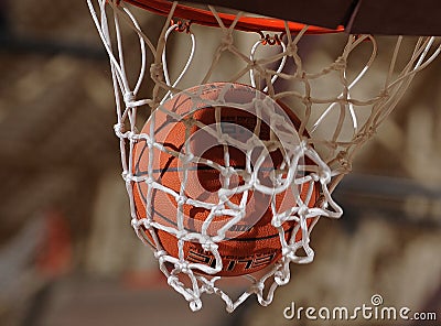 Basketball Going Through A Basketball Hoop. Editorial Stock Photo