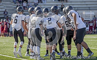 High school football players huddling Stock Photo