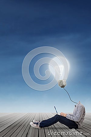 High school student with lamp head using laptop Stock Photo