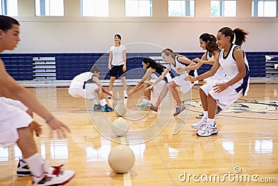 High School Students Playing Dodge Ball In Gym Stock Photo