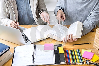 High school tutor or college student group sitting at desk in li Stock Photo