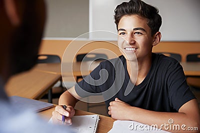 High School Tutor Giving Male Student One To One Tuition At Desk Stock Photo