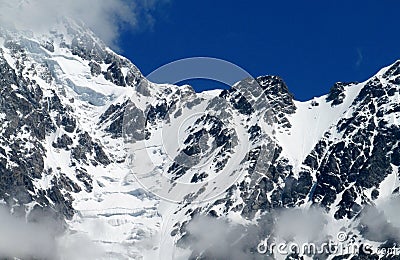 High snow and rocky mountain range Stock Photo