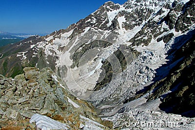 High snow and rocky mountain range and valley Stock Photo