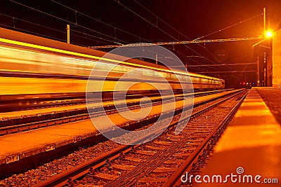 High speed passenger train on tracks with motion blur effect at night. Railway station in the Czech Republic Stock Photo