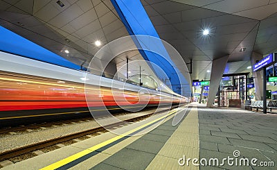 High speed train in motion on the railway station at night Stock Photo